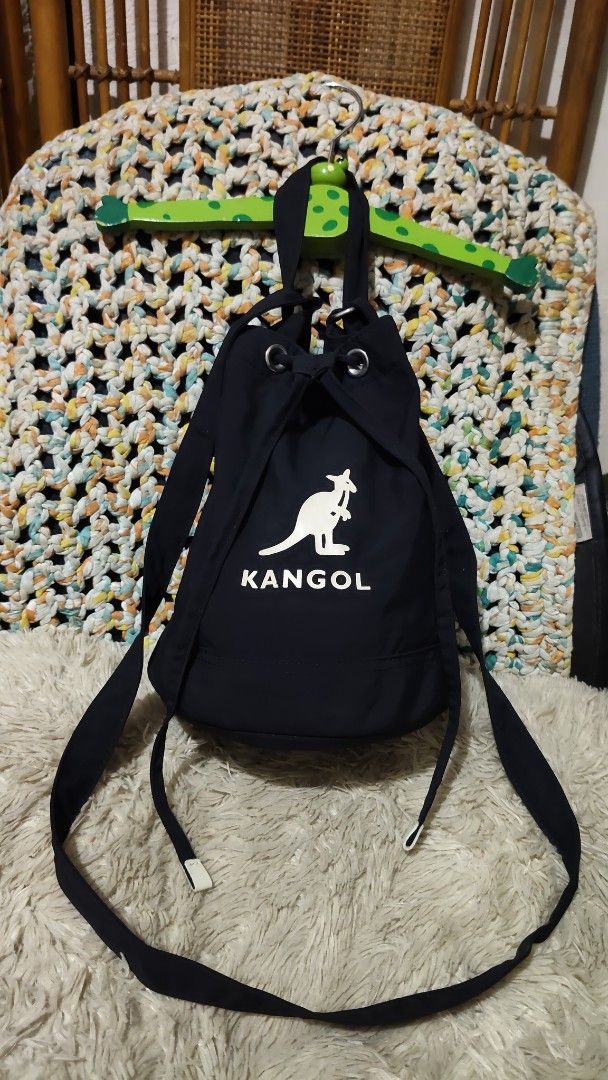 Kangol Black Drawstring Bucket Bag (Category: Cross-body Bags) located in Cebu City. Submitted by lumaynojes00490 (Listing ID 1468071421, Image 3). Description: - Brand: Kangol - Color: Classic black with white front logo - Closure: Secure drawstring with metal grommets - Versatile Carry: Includes a top grab handle and a long adjustable strap for shoulder or crossbody wear - Everyday Use: Spacious enough to fit all your daily essentials comfortab