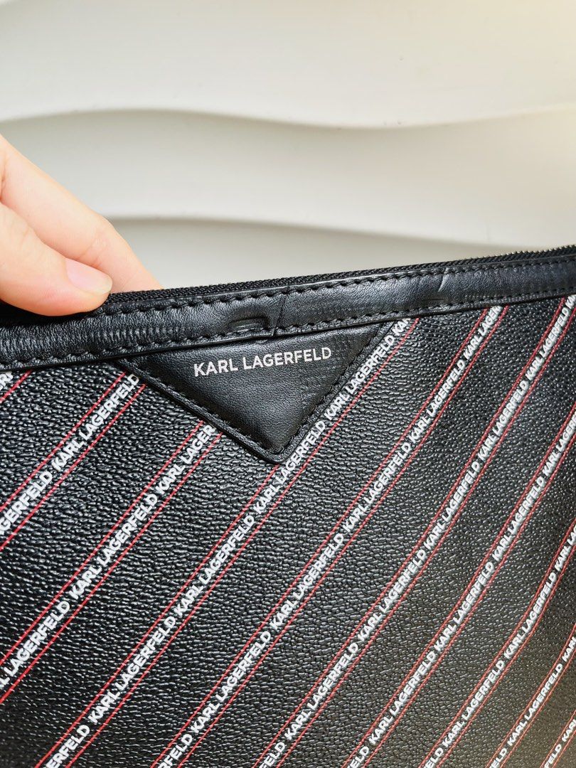 Karl Lagerfeld Monogram Pouch Clutch (Category: Luxury Bags & Wallets) located in Davao. Submitted by goodthingsph_ (Listing ID 1468076119, Image 2). Description: - Brand: Karl Lagerfeld - Material: Premium black faux leather - Design: All-over diagonal logo stripe with a branded triangle patch - Closure: Secure top zipper with a slim, sleek profile - Interior: Dark lining complete with official Karl Lagerfeld fabric tag - Condition: Brand new / 