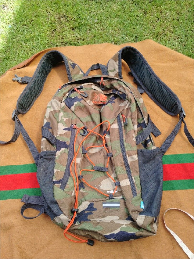 Karrimor Urban Camouflage Backpack (Category: Backpacks) located in Legazpi City. Submitted by genobecollectives (Listing ID 1468079389, Image 1). Description: - Brand: Karrimor - Design: Urban camo pattern (brown, green, black) with striking orange bungee cord - Storage: Main compartment with interior slip pocket and convenient mesh side pockets - Comfort: Padded mesh shoulder straps for all-day wear - Material: 100% durable polyester - Conditio