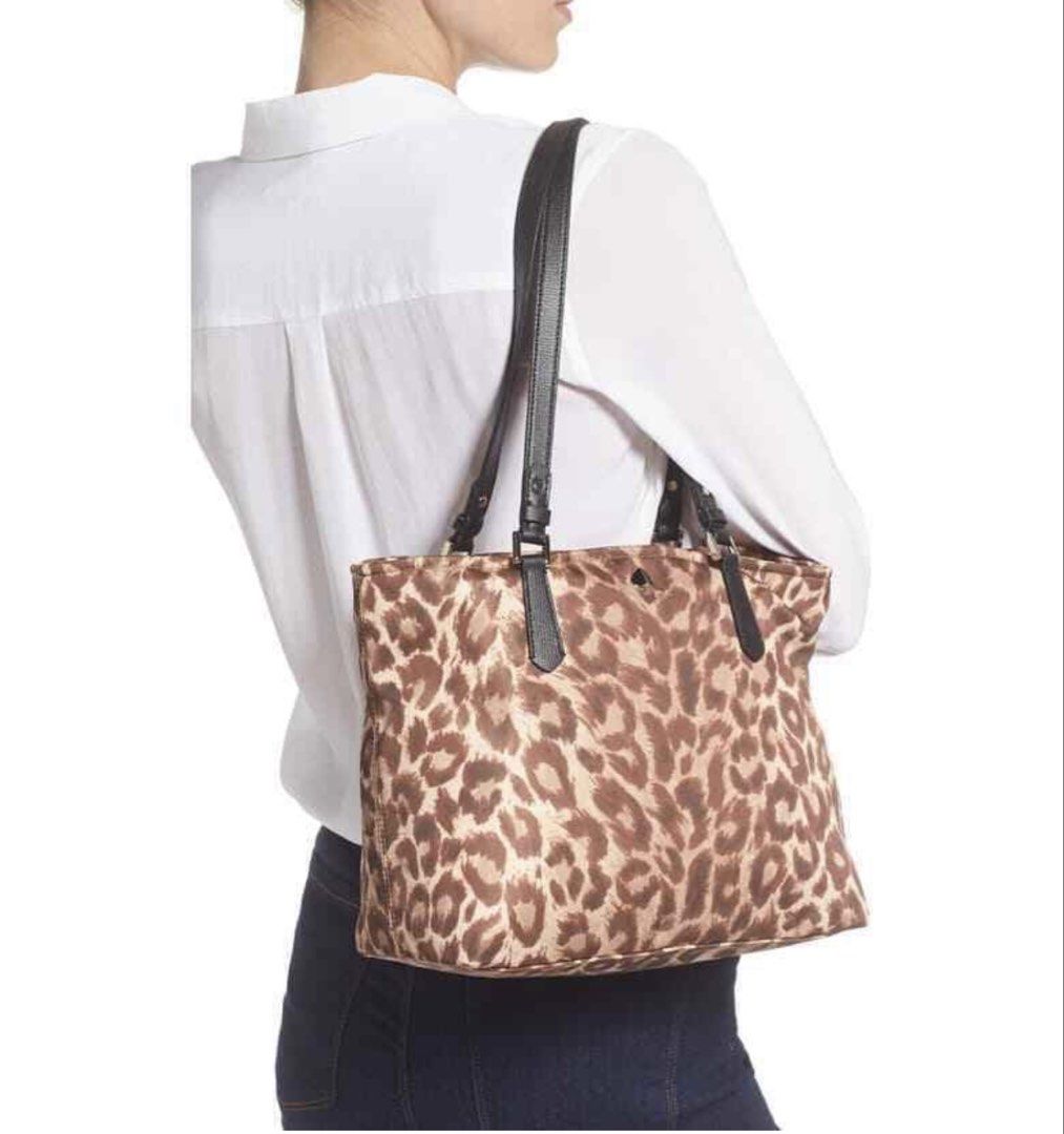 Kate Spade Leopard Print Nylon Tote Bag (Category: Tote Bags) located in Manila. Submitted by meegy (Listing ID 1468111747, Image 2). Description: - Authentic Kate Spade tote bag - Bold brown and tan leopard print fabric with chic black leather shoulder straps - Secure top zipper closure to keep your belongings safe - Spacious interior easily fits daily essentials - Features iconic metal Spade logo hardware .