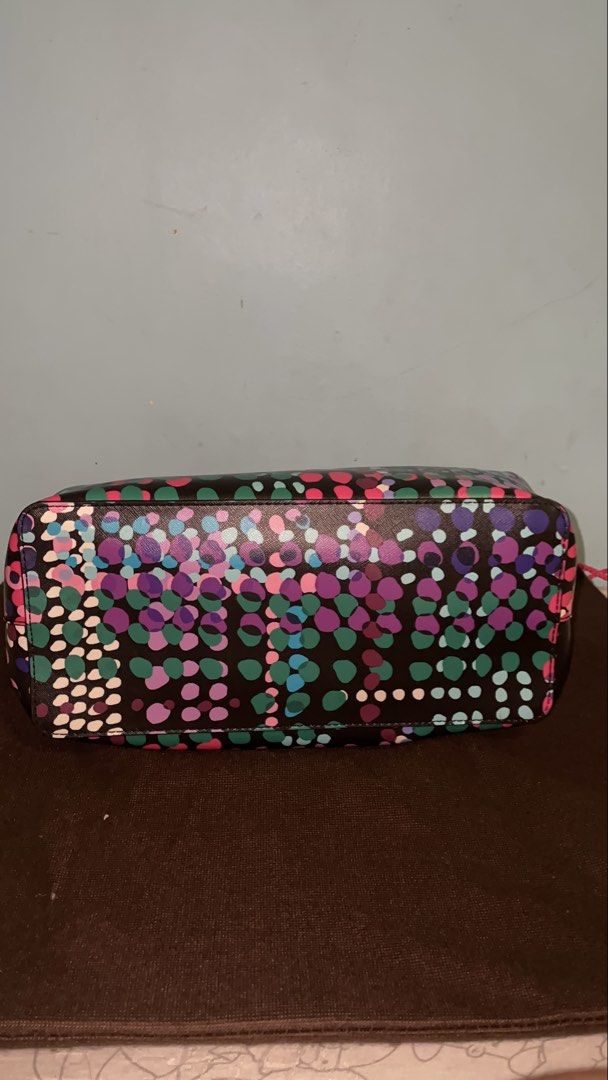 Kate Spade New York Dot Print Handbag (Category: Tote Bags) located in Manila. Submitted by ryoughhthrift (Listing ID 1468094933, Image 2). Description: - Brand: Kate Spade New York - Design: Vibrant multi-color dot pattern on a dark base with elegant gold-tone hardware - Features: Double top handles, structured shape, reinforced base, and a roomy interior for daily essentials - Inclusion: Matching brown dust bag with gold lettering - Condition: 