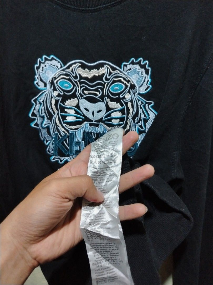 Kenzo Black Tiger Embroidered Sweatshirt (Category: Coats, Jackets and Outerwear) located in Caloocan City. Submitted by vincefresn21903 (Listing ID 1468281939, Image 3). Description: Black Kenzo sweatshirt with the iconic tiger head embroidered on the chest. Long sleeves, ribbed crew neckline, cuffs, and hem. Iconic Paris branding right under the tiger graphic. Inside tag and care label intact. Comfortable cotton material..