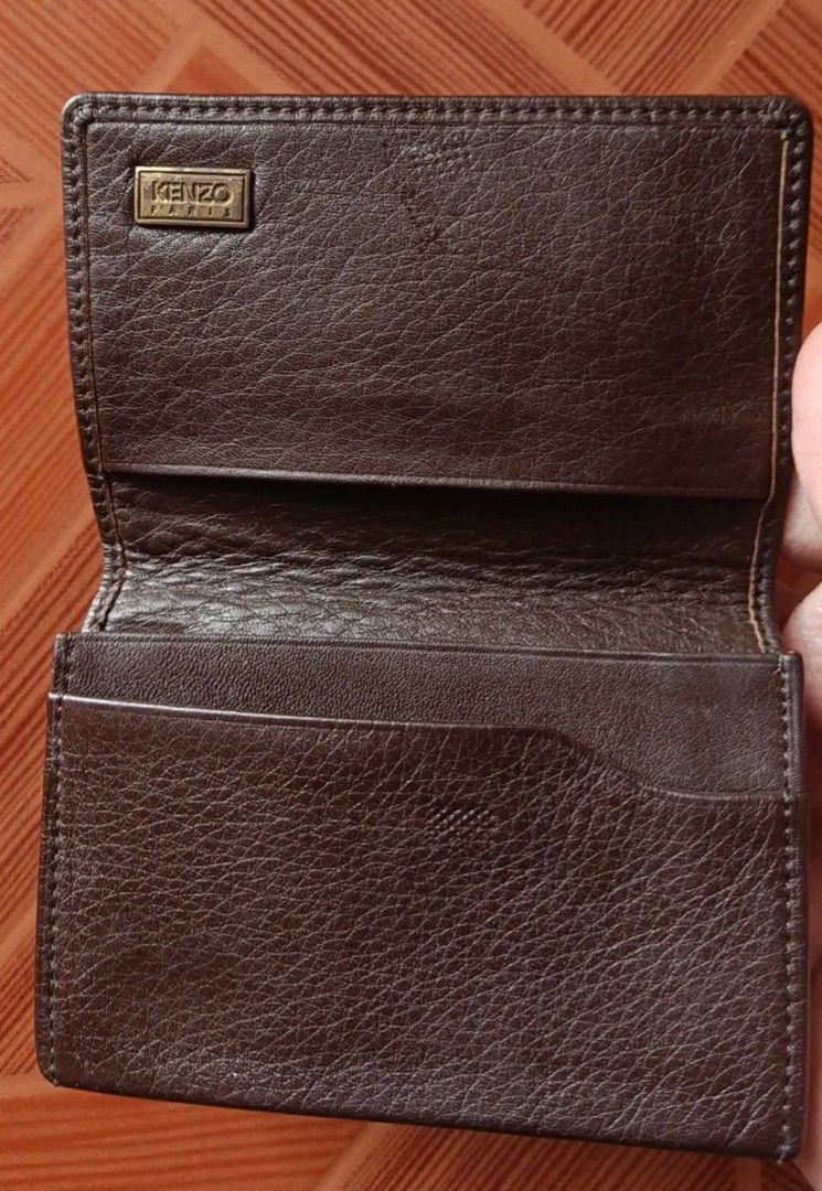 Kenzo Paris Brown Leather Card Holder (Category: Wallets & Card holders) located in Manila. Submitted by _bluberr (Listing ID 1468280155, Image 2). Description: - Brand: Kenzo Paris - Material: Genuine leather with pebbled texture - Color: Brown - Hardware: Gold-tone metal logo plaque on the front - Interior: Multiple card slots for cards and cash - Size: Compact, easily fits in pockets and bags - Condition: Excellent, clean interior and exterior