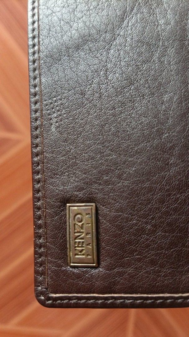 Kenzo Paris Brown Leather Card Holder (Category: Wallets & Card holders) located in Manila. Submitted by _bluberr (Listing ID 1468280155, Image 3). Description: - Brand: Kenzo Paris - Material: Genuine leather with pebbled texture - Color: Brown - Hardware: Gold-tone metal logo plaque on the front - Interior: Multiple card slots for cards and cash - Size: Compact, easily fits in pockets and bags - Condition: Excellent, clean interior and exterior