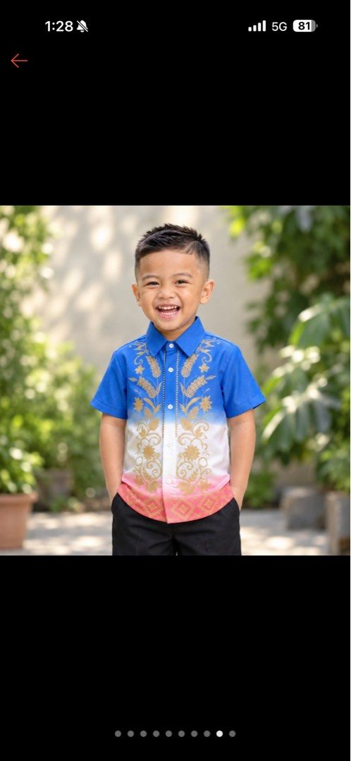 Kids Modern Gradient Barong Tagalog Shirt (Category: Babies & Kids Fashion) located in San Ildefonso. Submitted by regine_closet (Listing ID 1468099897, Image 1). Description: - Style: Short-sleeve boys' Barong Tagalog with a modern blue, white, and pink gradient - Details: Traditional gold floral embroidery down the front placket and standard button-down collar with white buttons - Condition: Excellent and clean, worn only once for a school clos