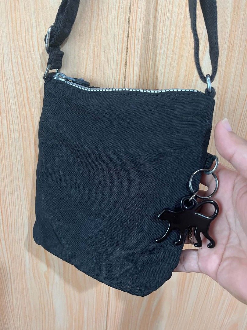 Kipling Black Crossbody Bag K15047-900 (Category: Cross-body Bags) located in Daraga. Submitted by thethriftcity2024 (Listing ID 1468104983, Image 3). Description: - Authentic black Kipling crossbody bag (Model K15047-900) - Crafted from durable, lightweight nylon material - Multiple exterior zippered pockets with signature round pull tags - Long adjustable strap for a comfortable, custom fit - Includes the iconic black monkey keychain - Compact 