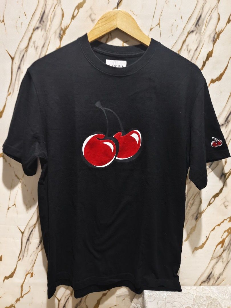 Kirsh Black Cherry Logo Tee Size 1 (Category: Shirts) located in Bayugan. Submitted by boss_rej (Listing ID 1468189177, Image 1). Description: - Brand: Kirsh (Made in South Korea) - Color: Black with iconic large cherry graphic on front & embroidered cherry on sleeve - Size: Size 1 (Standard fit, short sleeve crewneck) - Material: 100% Cotton (Machine washable) - Authenticity: Includes interior brand tag and QR code authentication tag on care lab