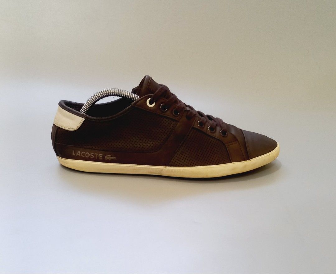 Lacoste Brown Perforated Leather Sneakers (Category: Sneakers) located in Cebu City. Submitted by MrLiks_123 (Listing ID 1468105195, Image 2). Description: - Brand: Lacoste - Material: Premium brown leather - Design: Classic low-top with dark brown laces - Details: Perforated sides and top for breathability - Accents: Contrasting cream heel patch and debossed crocodile logo - Sole: Durable matching rubber sole - Style: Versatile everyday casual w
