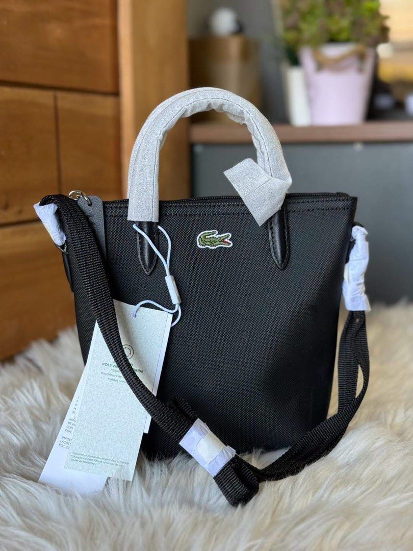 Lacoste Mini Tote Crossbody Bag Multiple Colors Available (Category: Cross-body Bags) located in Manila. Submitted by clairetot (Listing ID 1468131192, Image 1). Description: Authentic Lacoste mini tote bags available in black, pastel yellow, and soft pink. Features top handles, an adjustable and detachable shoulder strap, the iconic front crocodile logo, and original store tags. Brand new in plastic packaging..