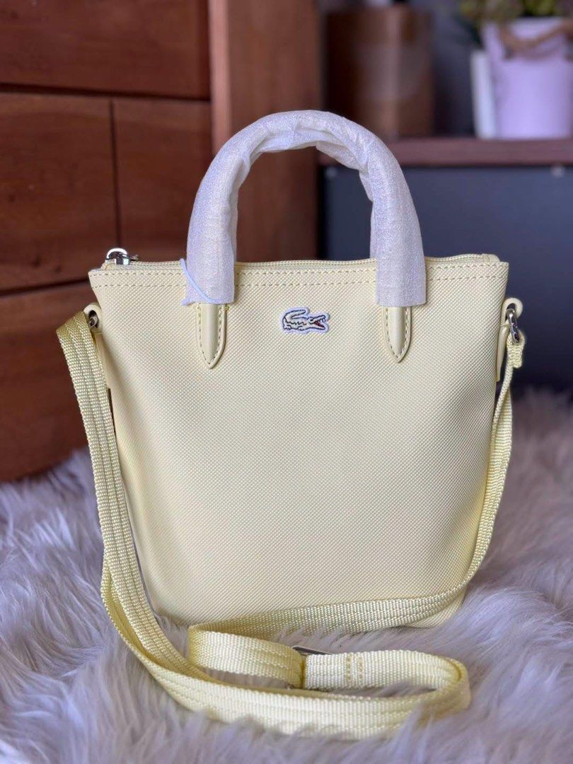 Lacoste Mini Tote Crossbody Bag Multiple Colors Available (Category: Cross-body Bags) located in Manila. Submitted by clairetot (Listing ID 1468131192, Image 3). Description: Authentic Lacoste mini tote bags available in black, pastel yellow, and soft pink. Features top handles, an adjustable and detachable shoulder strap, the iconic front crocodile logo, and original store tags. Brand new in plastic packaging..