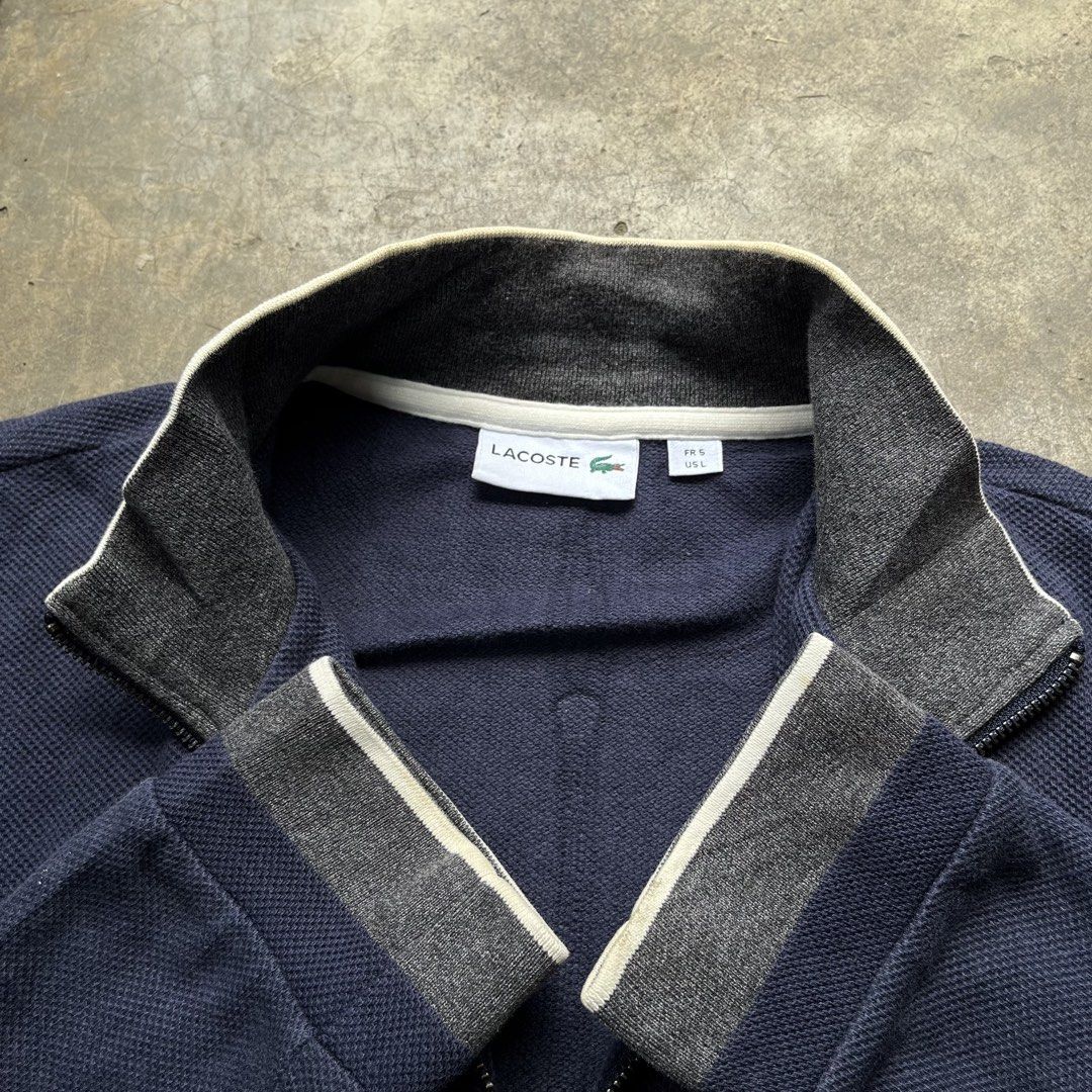 Lacoste Navy Blue Full Zip Jacket (Category: Coats, Jackets and Outerwear) located in Davao. Submitted by charlesole52665 (Listing ID 1468096477, Image 3). Description: - Brand: Lacoste - Size: 5 on tag(L fit to XL) - Width: 24 inch - Length: 27.5 inch - Style: Full zip jacket with dual zipper pullers - Color: Navy blue body with grey collar/cuffs and white trim - Size: US L / French 5 - Material: Textured knit cotton - Details: Classic embroider