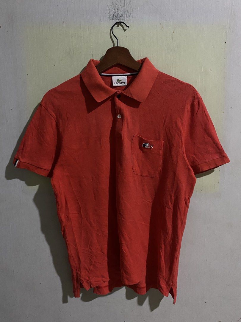 lacoste polo shirt (Category: Tshirts & Polo Shirts ) located in Pandi. Submitted by nasya_thrift_collection2023 (Listing ID 1468233801, Image 1). Description: - Brand: Devanlay - Color: Bright red - Material: Classic piqué fabric texture - Design: Standard button placket and collar - Fit: Comfortable, great for everyday casual wear - Care Instructions: Machine wash warm at 40°C, warm iron at 150°C, do not bleach, do not tumble dry, do not dry cl