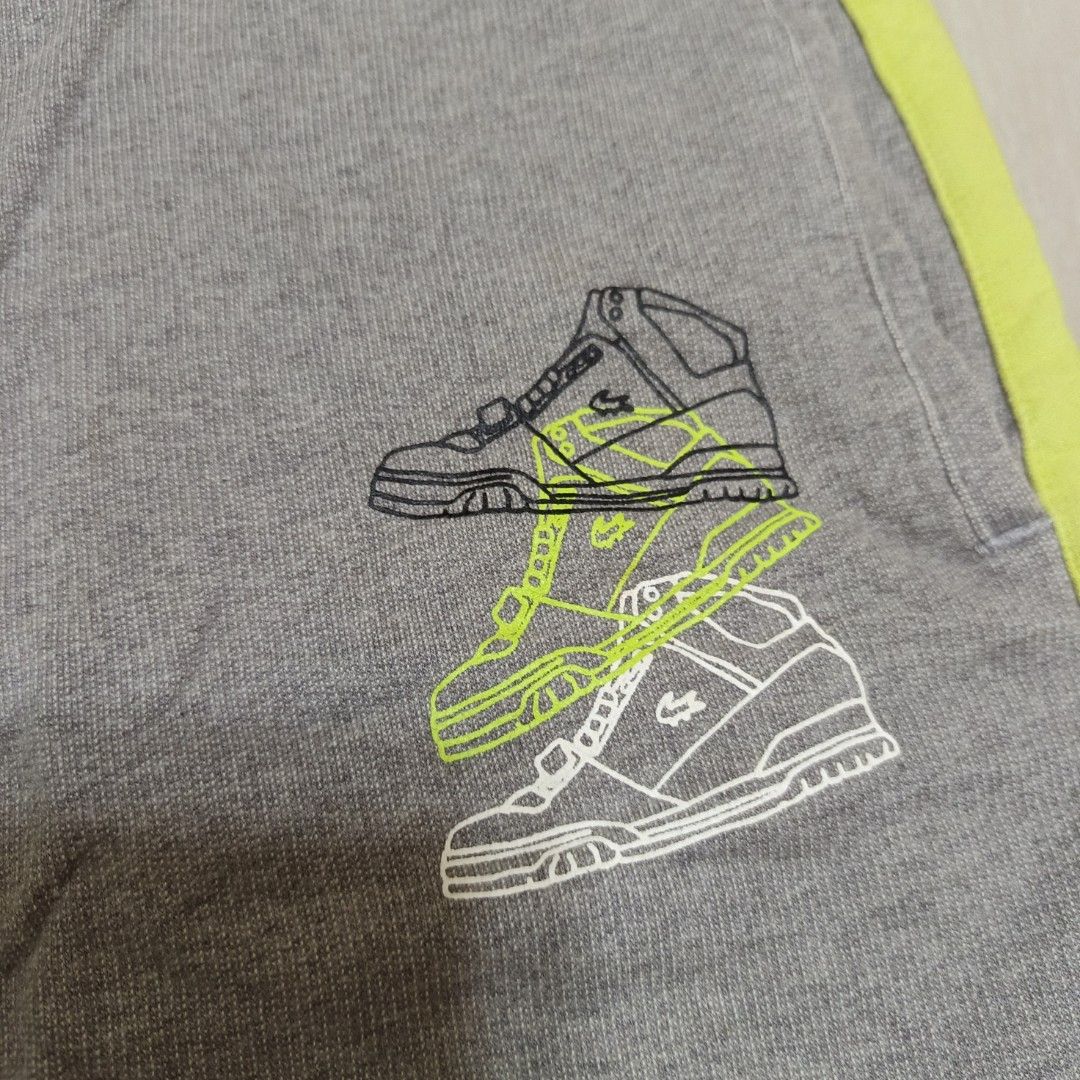 Lacoste Sport Grey Yellow Drawstring Shorts Size 3 (Category: Shorts) located in Nasugbu. Submitted by staffpicks1515 (Listing ID 1468223901, Image 3). Description: Grey Lacoste Sport shorts with vibrant yellow accents and drawstring waistband. Unique sneaker graphic printed on the right leg. Classic embroidered crocodile logo near the right pocket. Tagged size 3. Made from 100% cotton material. Includes two side pockets and one back pocket. Wais