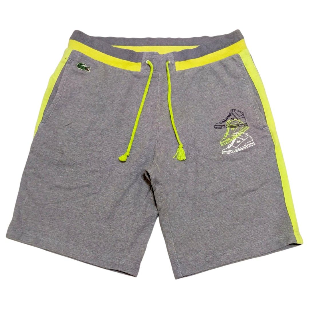 Lacoste Sport Grey Yellow Drawstring Shorts Size 3 (Category: Shorts) located in Nasugbu. Submitted by staffpicks1515 (Listing ID 1468223901, Image 2). Description: Grey Lacoste Sport shorts with vibrant yellow accents and drawstring waistband. Unique sneaker graphic printed on the right leg. Classic embroidered crocodile logo near the right pocket. Tagged size 3. Made from 100% cotton material. Includes two side pockets and one back pocket. Wais