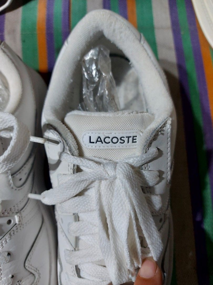 Lacoste White Sneakers (Category: Sneakers) located in Nabunturan. Submitted by creep012181 (Listing ID 1468209382, Image 3). Description: White Lacoste sneakers with classic crocodile logo on the side. Lace-up closure, chunky rubber sole, and perforated details on the toe and side panels. Clean white leather upper with matching laces. Comfortable everyday trainers with distinct branding on the tongue and heel area..