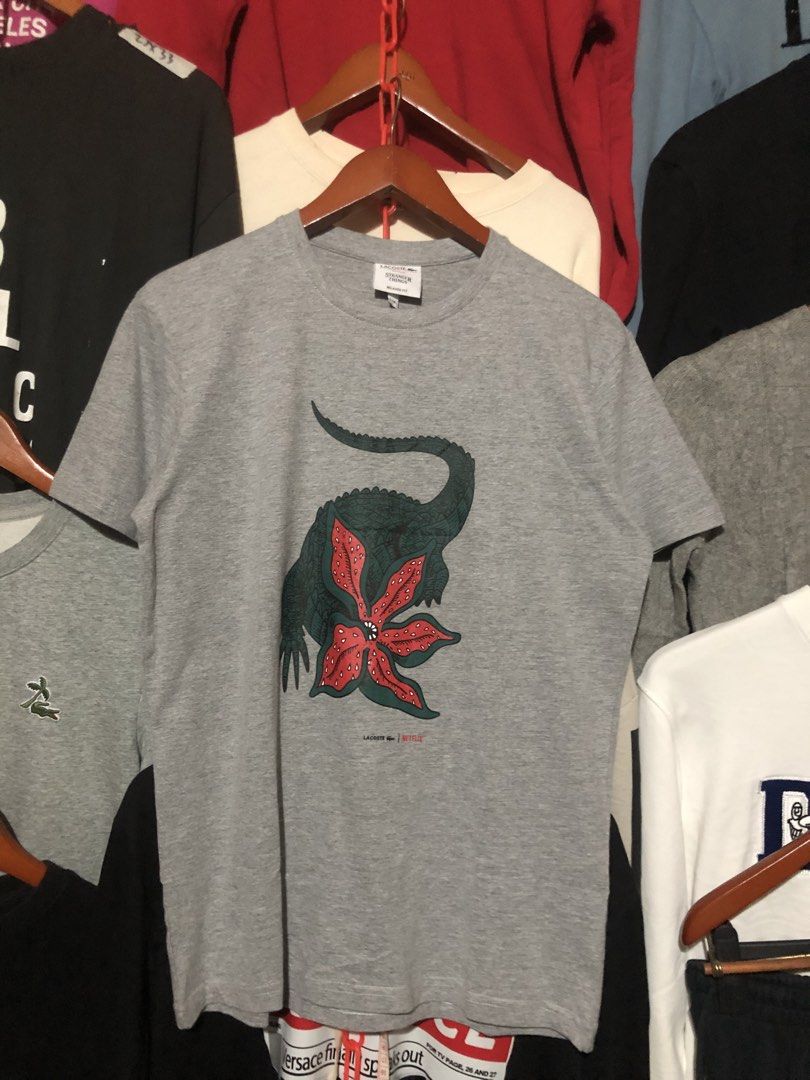 LACOSTE X NETFLIX SHIRT (Category: Tshirts & Polo Shirts ) located in Manila. Submitted by jazz_find5 (Listing ID 1468060671, Image 1). Description: LACOSTE X NETFLIX COLLAB SHIRT SIZE medium on tag 21,27 EXCELLENT ASNEW CONDITION.