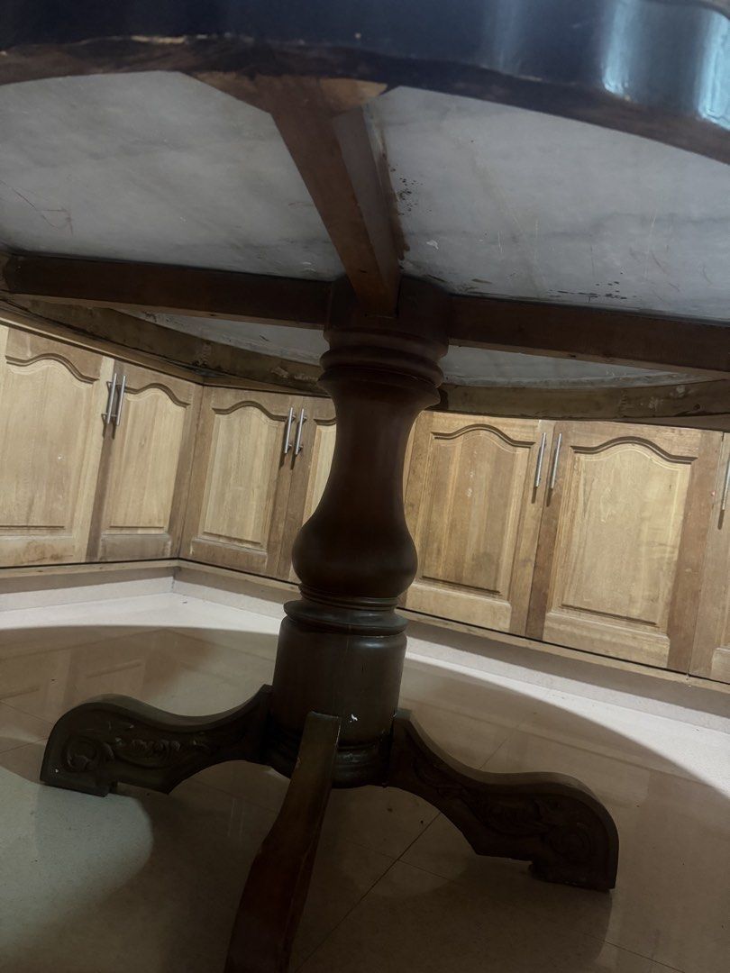 Large Round Wooden Dining Table with Pedestal Base (Category: Tables & Sets) located in Bulacan. Submitted by maryann1411 (Listing ID 1468139416, Image 3). Description: - Large round dining table with heavy, solid construction - Sturdy wooden pedestal base featuring carved feet - White center top with a decorative patterned yellow rim and dark edge trim - Comfortably seats several chairs, ideal for family dinners or kitchens - Shows normal surfac
