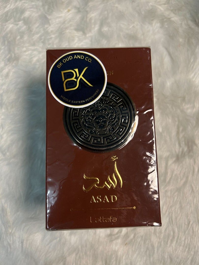 Lattafa Asad Bourbon Eau de Parfum (Category: Fragrance & Deodorants) located in Manila. Submitted by bk_oud_co (Listing ID 1468226341, Image 1). Description: - Brand: Lattafa Asad - Volume: 3.4 fl oz (100ml) - Condition: Brand new, 100% authentic, and sealed in original plastic wrap - Packaging: Distinctive brown box featuring gold Arabic calligraphy and a striking lion emblem - Scent Profile: Highly rated, popular Middle Eastern fragrance known