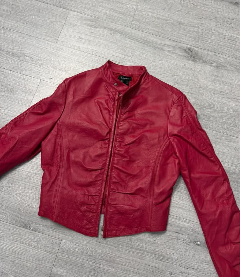 Le Chateau Red Leather Jacket (Category: Coats, Jackets and Outerwear) located in Manila. Submitted by silentwhale_543e69 (Listing ID 1468174832, Image 2). Description: - Brand: Le Château - Type: Red leather jacket - Size: xs to medium - Closure: Front zip with stylish ruching details - Cuffs: Zipper cuffs on sleeves - Collar: High collar with a snap button tab - Interior: Lined for comfort - Condition: Great statement piece .