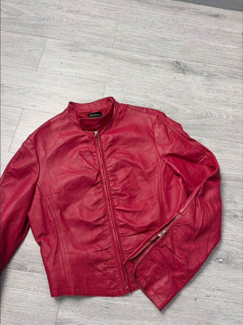 Le Chateau Red Leather Jacket (Category: Coats, Jackets and Outerwear) located in Manila. Submitted by silentwhale_543e69 (Listing ID 1468174832, Image 1). Description: - Brand: Le Château - Type: Red leather jacket - Size: xs to medium - Closure: Front zip with stylish ruching details - Cuffs: Zipper cuffs on sleeves - Collar: High collar with a snap button tab - Interior: Lined for comfort - Condition: Great statement piece .