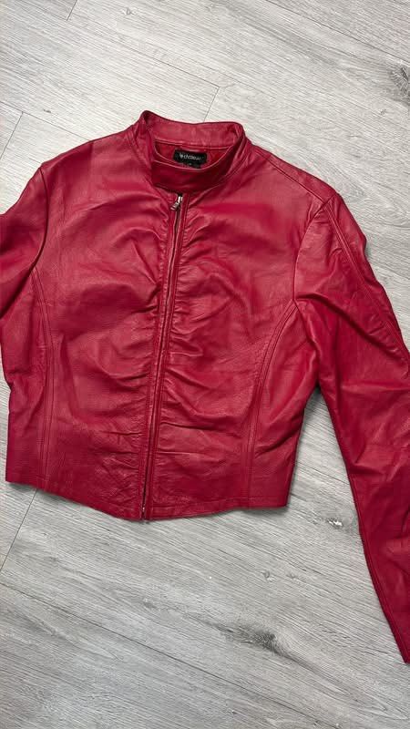 Le Chateau Red Leather Jacket (Category: Coats, Jackets and Outerwear) located in Manila. Submitted by silentwhale_543e69 (Listing ID 1468174832, Image 3). Description: - Brand: Le Château - Type: Red leather jacket - Size: xs to medium - Closure: Front zip with stylish ruching details - Cuffs: Zipper cuffs on sleeves - Collar: High collar with a snap button tab - Interior: Lined for comfort - Condition: Great statement piece .