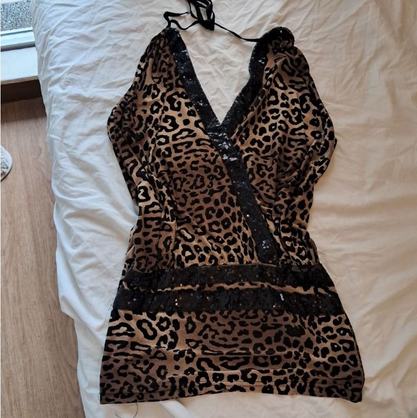 Leopard print halter top with sequin trim (Category: Sleeveless) located in Quezon City. Submitted by SustainableFashionatbp (Listing ID 1468073517, Image 3). Description: - Style: animal print halter top with black straps - Details: Sparkling black sequins along the V-neckline and waist band - Fit: Lightweight, stretchy, and comfortable for all-night wear, can fit XS-M since it's stretchy - Occasion: Perfect statement piece for parties and going