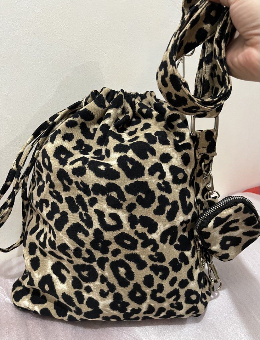 Leopard Print Velvet Drawstring Shoulder Bag with Mini Pouch (Category: Shoulder Bags) located in Talisay. Submitted by cherylu (Listing ID 1468265773, Image 3). Description: Leopard print velvet shoulder bag with drawstring closure. Soft fabric material. Adjustable matching strap attached with silver-toned hardware. Includes a matching mini zipped pouch clip-on. Spacious interior for daily essentials. Trendy and casual everyday carryall..