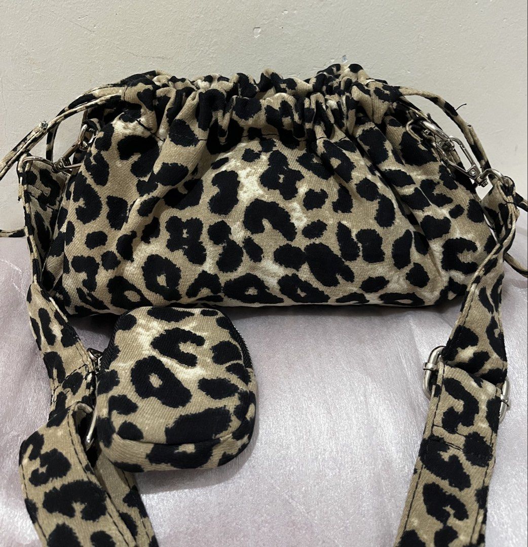 Leopard Print Velvet Drawstring Shoulder Bag with Mini Pouch (Category: Shoulder Bags) located in Talisay. Submitted by cherylu (Listing ID 1468265773, Image 2). Description: Leopard print velvet shoulder bag with drawstring closure. Soft fabric material. Adjustable matching strap attached with silver-toned hardware. Includes a matching mini zipped pouch clip-on. Spacious interior for daily essentials. Trendy and casual everyday carryall..