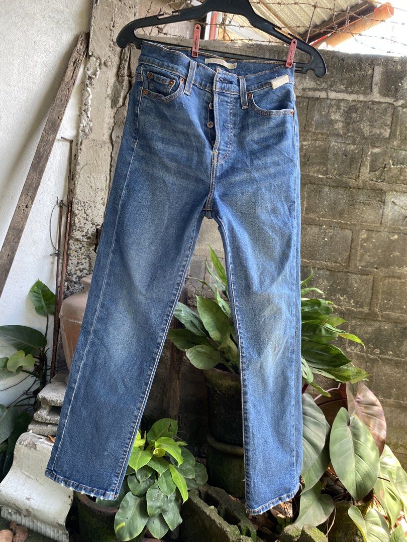 Levi's Wedgie Straight Jeans Size 26 (Category: Jeans) located in Pulupandan. Submitted by pointyspoon (Listing ID 1468080923, Image 1). Description: - Brand: Levi's - Style: Wedgie Straight jeans - Color/Wash: Medium blue with front thigh fading - Size: Tag size 26 Tape Measure: 26 in waist 26 in inseam 36 in outseam 14 in leg opening - Fit: High-waisted and straight leg - Details: Button fly closure and classic five-pocket styling.