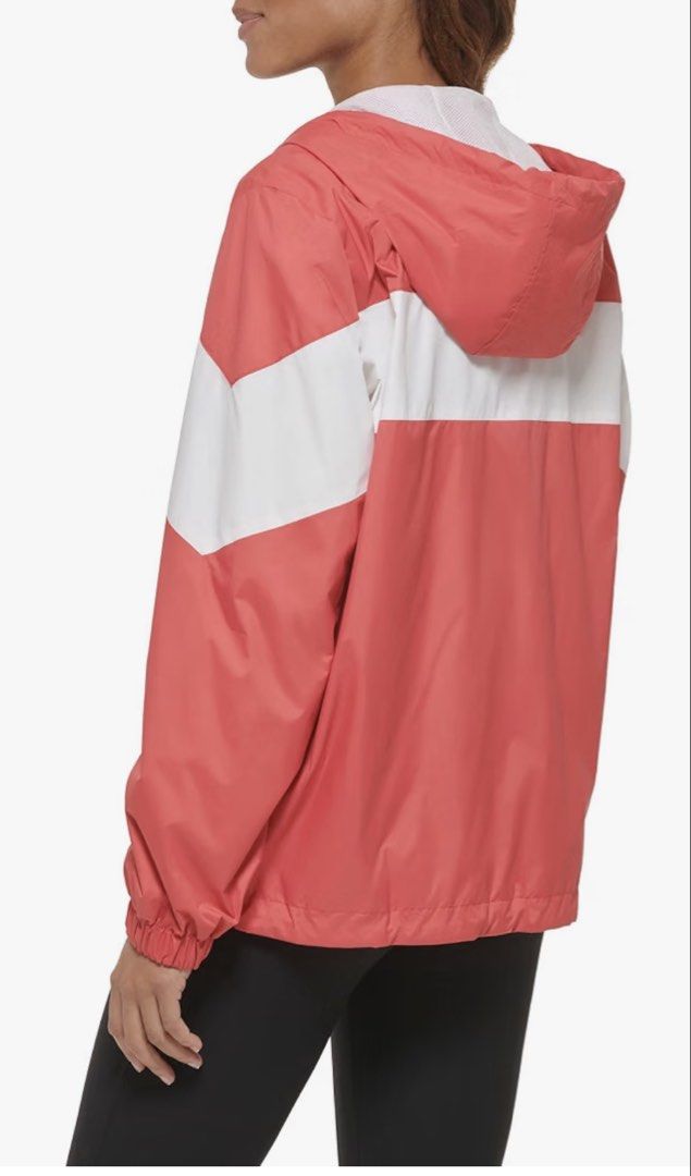 Levi's Windbreaker Coral Combo Medium (Category: Coats, Jackets and Outerwear) located in Quezon City. Submitted by jamboreeee (Listing ID 1468234113, Image 2). Description: Levi's colorblock windbreaker in coral combo. Size Medium. White zip front, hood with drawstrings, mesh lining inside. Two-tone coral and white chevron panel design across the chest and sleeves. Elastic cuffs and adjustable hem drawcords. Original store tag still attached to 