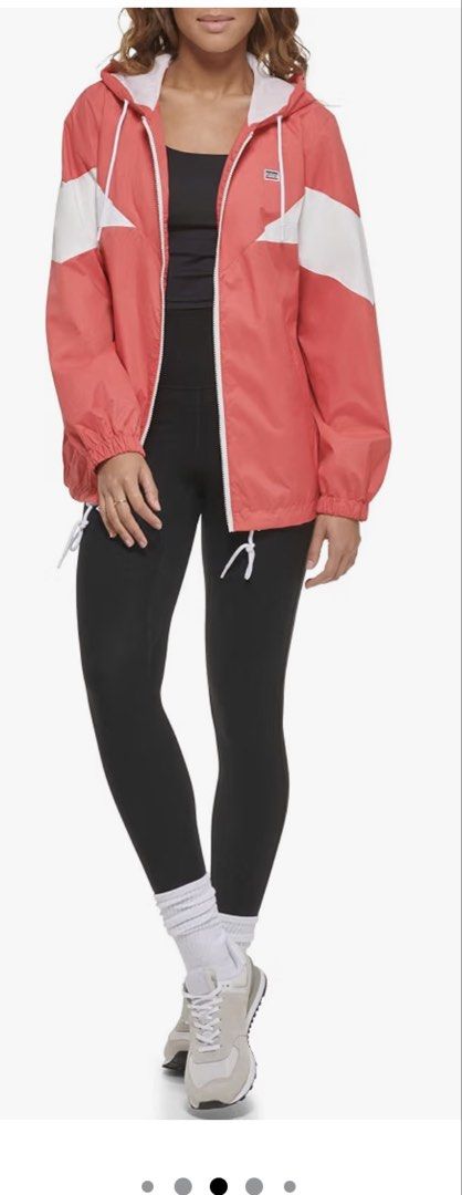 Levi's Windbreaker Coral Combo Medium (Category: Coats, Jackets and Outerwear) located in Quezon City. Submitted by jamboreeee (Listing ID 1468234113, Image 3). Description: Levi's colorblock windbreaker in coral combo. Size Medium. White zip front, hood with drawstrings, mesh lining inside. Two-tone coral and white chevron panel design across the chest and sleeves. Elastic cuffs and adjustable hem drawcords. Original store tag still attached to 