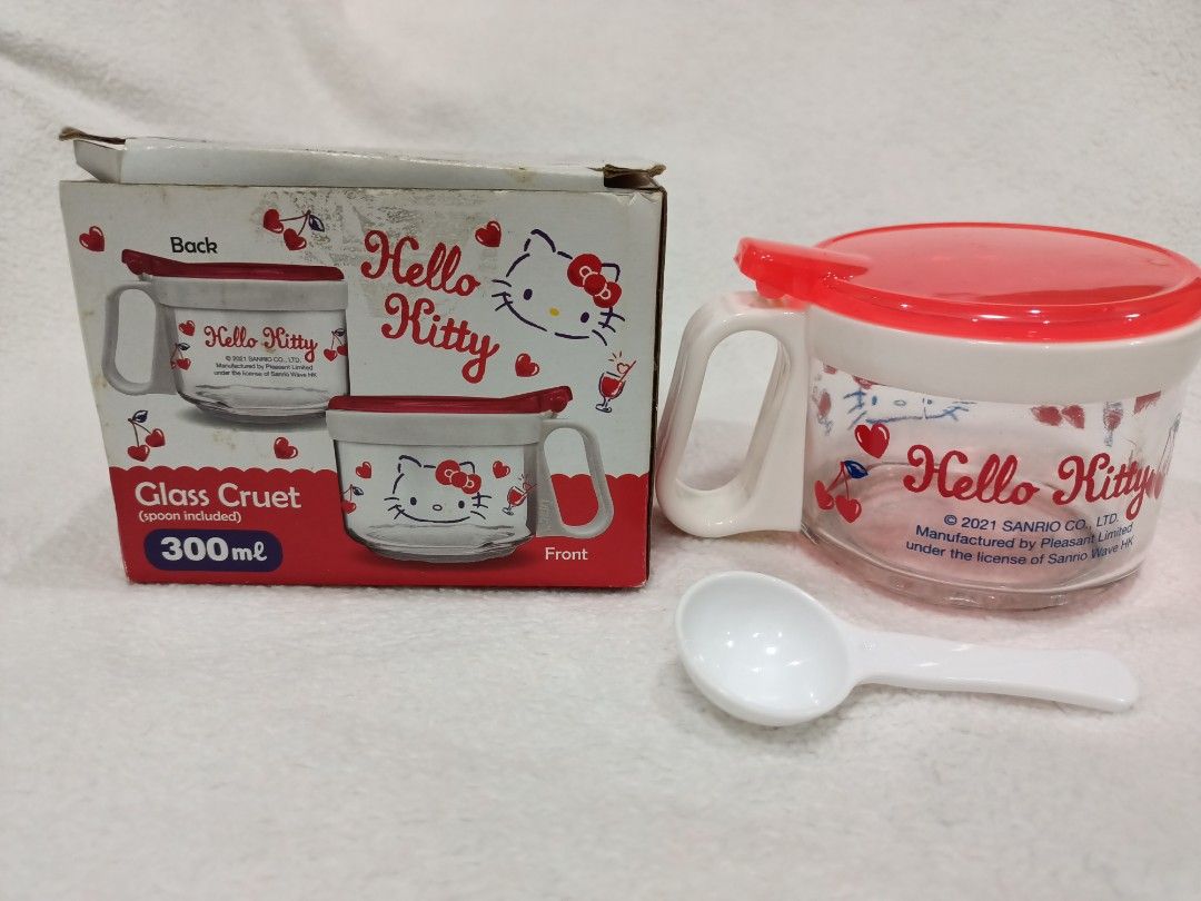 License Hello Kitty Glass Condiment Container with Spoon 300ml (Category: Food Organization & Storage) located in Manila. Submitted by jollynest24 (Listing ID 1468223122, Image 2). Description: - License Hello Kitty Glass Condiment Container ( Brand New) - Capacity: 300ml, ideal for kitchen condiments or table use - Features adorable Kitty graphics and cherry motifs all around - Clear glass body paired with a charming red and white lid and handle