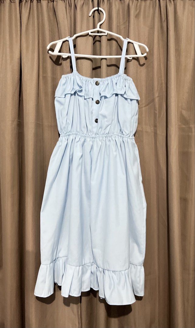 Light Blue Spaghetti Strap Ruffle Dress (Category: Dresses) located in Cainta. Submitted by periwinkle.ph (Listing ID 1468200643, Image 1). Description: - Color: Light blue - Style: Spaghetti strap sundress - Details: Cute ruffle trim on neckline and hem, 3 brown decorative buttons down the front - Comfort: Elastic waist for an easy, comfortable fit - Fabric: Lightweight and breathable, perfect for warm weather.