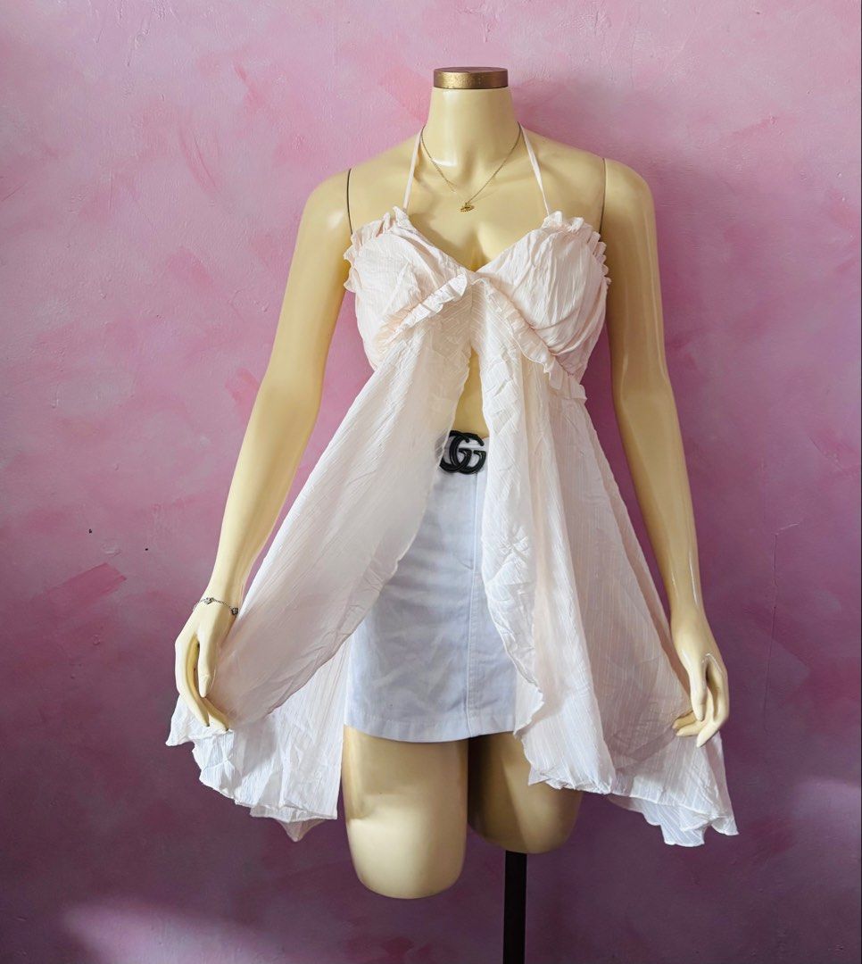Light Pink Halter Neck Ruffle Open Front Top (Category: Sleeveless) located in Lipa City. Submitted by classyces24 (Listing ID 1468281969, Image 1). Description: - Color: Light pink with subtle vertical stripes - Design: Halter neck with adjustable neck ties - Details: Ruffled trim along the bust and a flowing open front - Fabric: Lightweight and breathable, ideal for sunny days - Styling: Perfect for warm weather or pairing with your favorite sh