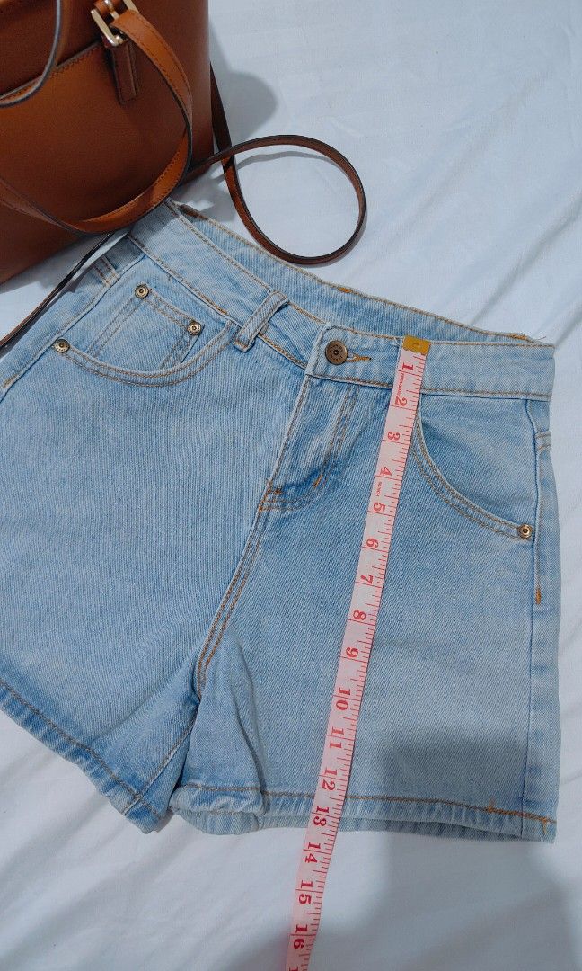Light wash high waisted denim shorts (Category: Shorts) located in Bacolor. Submitted by annjjjjj (Listing ID 1468083054, Image 3). Description: - Style: Light wash, high-waisted denim shorts - Details: Classic metal button fly with orange contrast stitching - Pockets: Four-pocket setup plus a small front coin pocket - Fit: Medium length with clean edges - Versatility: Casual everyday piece, easy to style with basic tees and tops.