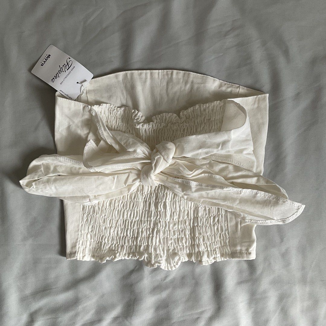 Linen White Multiway Tube Top (Category: Sleeveless) located in Quezon City. Submitted by declutter.chek (Listing ID 1468135616, Image 3). Description: - Brand: Sierra Manila (Filipina collection) - Color: White - Condition: Brand new with tags attached, never worn - Features: Structured front with panel seams, stretchy smocking back, and a large self-tie bow detail.