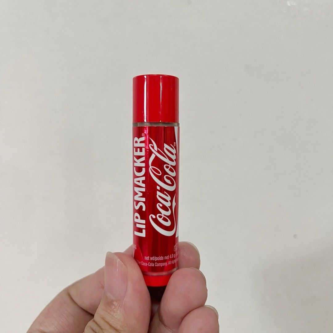 Lip Smacker Coca Cola Lip Balm (Category: Makeup) located in San Pedro. Submitted by rainyydayy (Listing ID 1468212057, Image 1). Description: Lip Smacker lip balm with classic Coca Cola flavor. Standard tube size containing 4.0 grams of product. Red packaging featuring the iconic Coca Cola logo. Great collector item or daily pocket lip care. Batch code printed on the bottom cap..