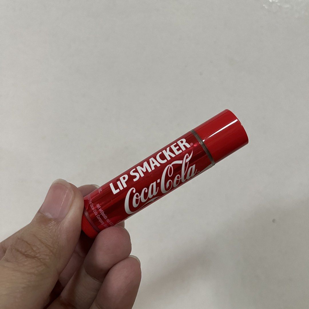 Lip Smacker Coca Cola Lip Balm (Category: Makeup) located in San Pedro. Submitted by rainyydayy (Listing ID 1468212057, Image 2). Description: Lip Smacker lip balm with classic Coca Cola flavor. Standard tube size containing 4.0 grams of product. Red packaging featuring the iconic Coca Cola logo. Great collector item or daily pocket lip care. Batch code printed on the bottom cap..