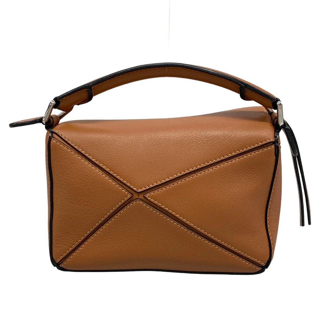 Loewe Mini Puzzle Bag Tan (Category: Shoulder Bags) located in Las Pinas. Submitted by daisuki_japan_luxury_by_reiko (Listing ID 1468077004, Image 3). Description: Condition Notes [Exterior] Main opening: Corner scuffs / Hardware deterioration ; Handle: Corner scuffs / Dirt / Stains ; Bottom: Corner scuffs ; Overall: Loss of shape. [Interior] Overall: Scratches (some pilling) / Dirt. [Special Notes] Main body: Accessories (slight dirt on the dust