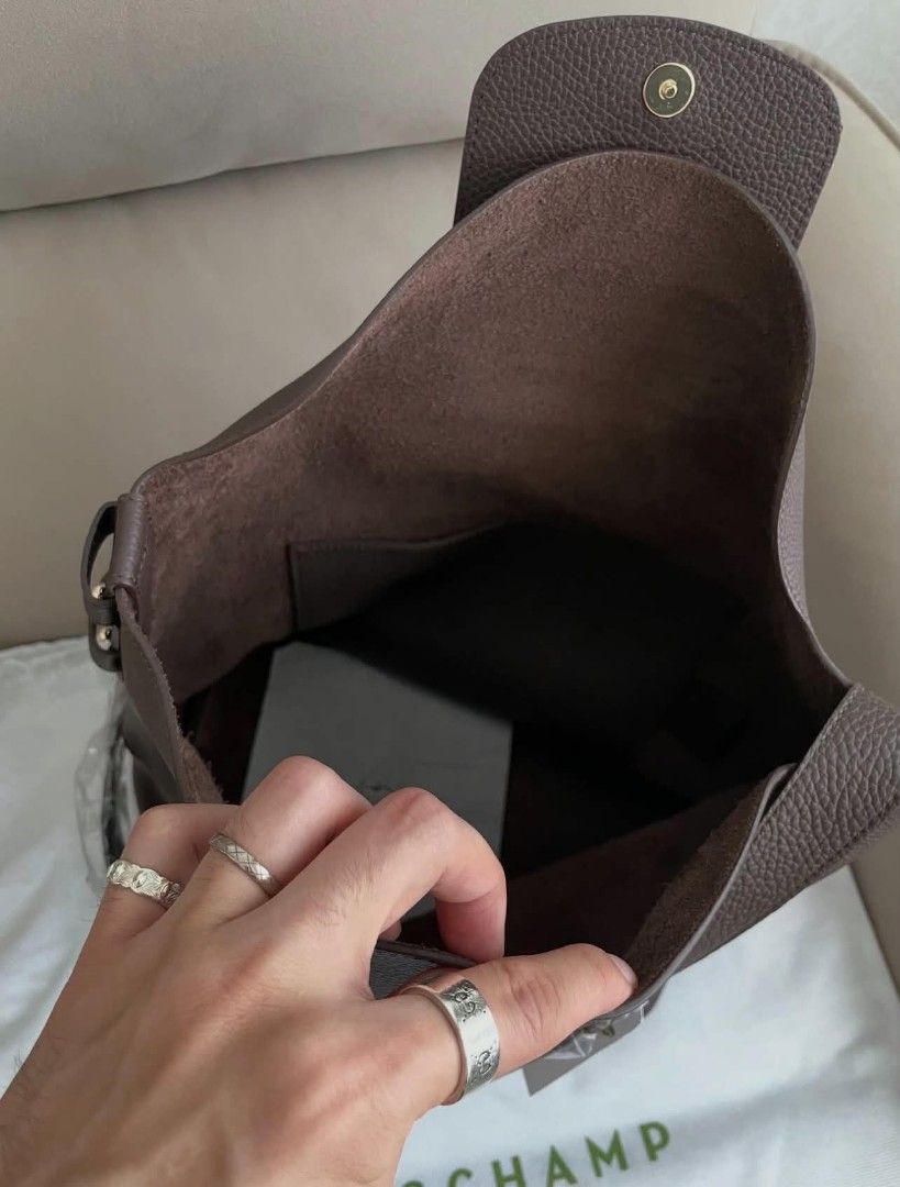 Longchamp Cadence L Shoulder Bag (Category: Shoulder Bags) located in Paoay. Submitted by rvf1230 (Listing ID 1468143476, Image 3). Description: - Brand: Longchamp - Material: Rich dark brown grained leather - Hardware: Gold-tone studs - Strap: Adjustable shoulder strap - Closure: Front flap with snap button and embossed horse logo - Interior: Unlined with an open side pocket - Inclusions: Protective dust bag and store tag attached - Condition: B