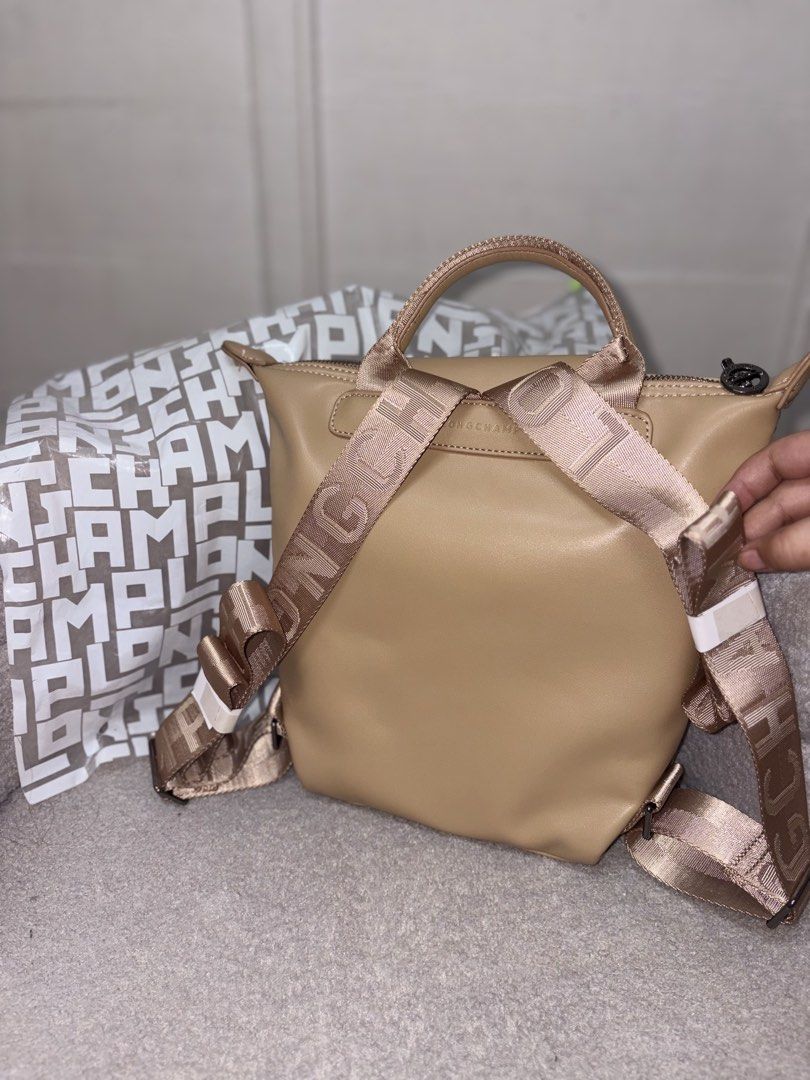 Longchamp Le Pliage Cuir Customized Backpack Taupe (Category: Backpacks) located in Manila. Submitted by axchichaaa (Listing ID 1468178107, Image 2). Description: - Brand: Longchamp - Color: Elegant Taupe - Material: Premium Leather with durable branded nylon straps - Closure: Foldover flap with snap button and secure main zippered compartment - Features: Structured shape with a convenient top handle and adjustable straps - Inclusion: Comes with 