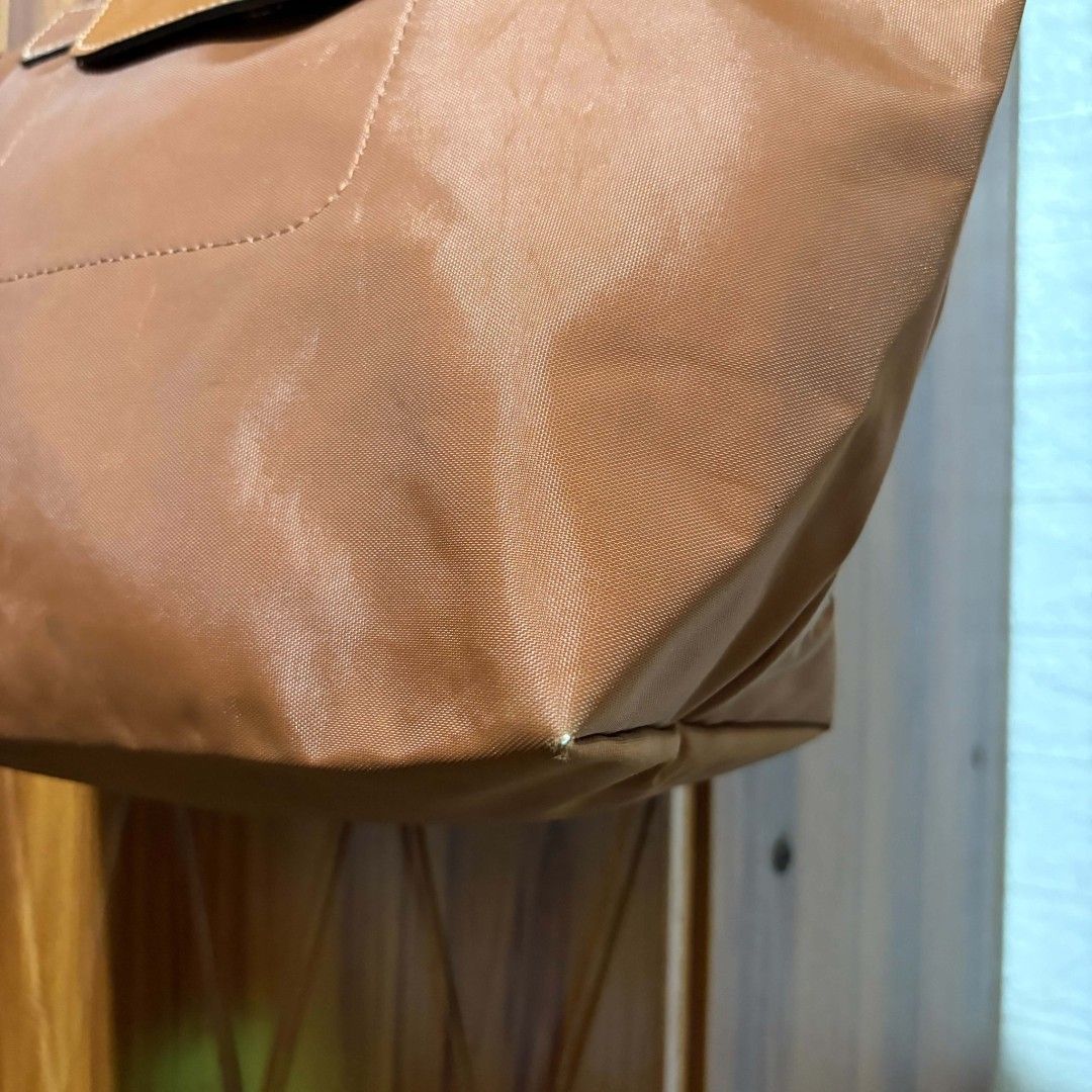 Longchamp Le Pliage Medium Tote Bag Brown (Category: Tote Bags) located in Carmen. Submitted by ar_thrift00 (Listing ID 1468282489, Image 3). Description: - Longchamp Le Pliage Medium Tote in Brown - Durable nylon body with stylish leather handles and flap closure - Elegant gold-tone hardware (zipper pull and snap button) - Stamped interior tag: Longchamp Paris, Made in France - Versatile and spacious for daily commutes, school, or travel - Condi
