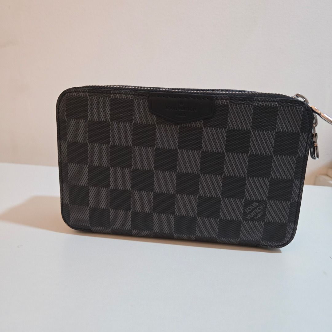 Louis Vuitton Alpha Wearable Wallet (Category: Luxury Bags & Wallets) located in Muntinlupa City. Submitted by luxor.alt123158 (Listing ID 1468227273, Image 1). Description: - Brand: Louis Vuitton - Style: Double Zip Pochette - Material: Iconic Damier Graphite canvas with black leather trim - Hardware: Silver-tone - Closure: Top zip closure - Interior: Clean lining with heat stamp, features multiple card slots and compartments - Condition: Guaran