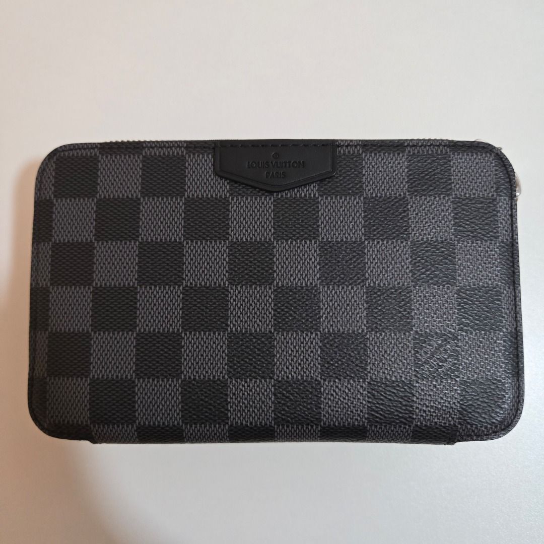 Louis Vuitton Alpha Wearable Wallet (Category: Luxury Bags & Wallets) located in Muntinlupa City. Submitted by luxor.alt123158 (Listing ID 1468227273, Image 3). Description: - Brand: Louis Vuitton - Style: Double Zip Pochette - Material: Iconic Damier Graphite canvas with black leather trim - Hardware: Silver-tone - Closure: Top zip closure - Interior: Clean lining with heat stamp, features multiple card slots and compartments - Condition: Guaran