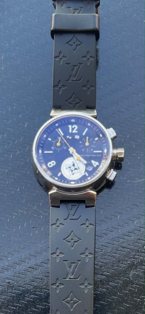 Louis Vuitton Cup Chronograph Watch Black Rubber Strap (Category: Luxury Watches) located in Manila. Submitted by zackthrift16 (Listing ID 1468208562, Image 1). Description: - Model: Louis Vuitton Cup Chronograph - Dial: Blue with white numbers, sub-dials, and date window - Strap: Black rubber with embossed LV monogram pattern - Case Back: Stainless steel with serial numbers RT5242 and 0132G, plus Swiss Made markings - Movement: Chronograph with 