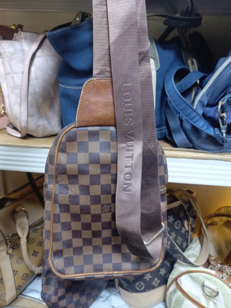 Louis Vuitton Damier Ebene Sling Bag (Category: Luxury Bags & Wallets) located in Manila. Submitted by del_thrifts03 (Listing ID 1468111132, Image 2). Description: - Stylish brown checkerboard pattern - Premium tan leather accent patch on front pocket and top handle - Comfortable branded fabric strap with adjustable metal buckle - Secure zip closure with engraved metal puller - Compact size, perfect for daily wear and essentials.