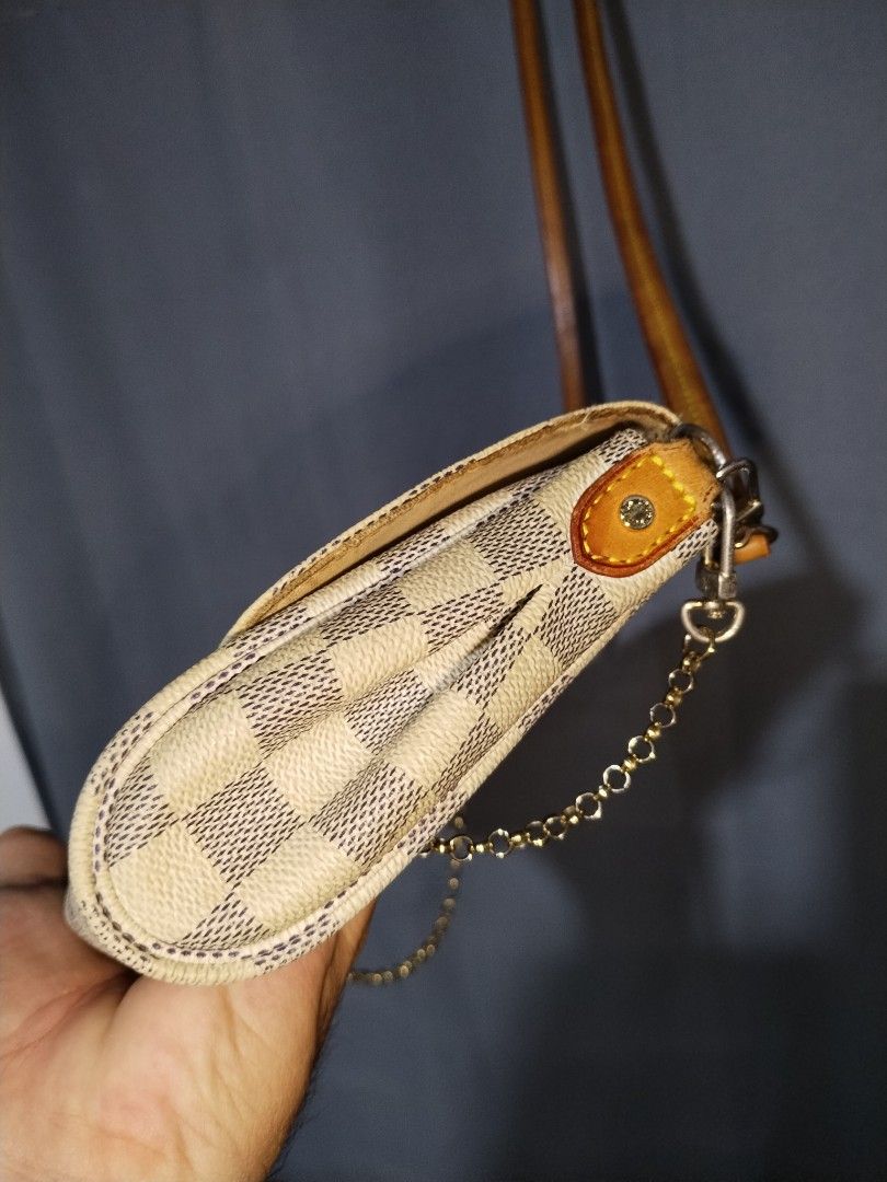 Louis Vuitton Damier Favorite Sling Bag (Category: Luxury Bags & Wallets) located in Pasig City. Submitted by loveforlux_2025 (Listing ID 1468283209, Image 3). Description: - Louis Vuitton crossbody bag - Classic Damier Azur white and blue checkerboard canvas - Premium tan leather strap, trim, and brown leather sides - Front flap with metal closure plate and trendy dangling gold-toned chain - Functional back design with dual snap buttons and pock