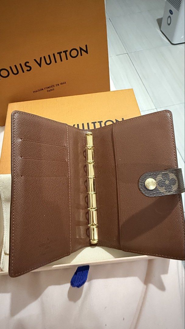 Louis Vuitton Monogram Small Ring Agenda PM (Category: Luxury Bags & Wallets) located in Caloocan City. Submitted by reizbuenaventura (Listing ID 1468278514, Image 2). Description: - Authentic Louis Vuitton Monogram PM Small Ring Agenda Cover - Classic brown monogram canvas with gold-tone hardware rings - Multiple interior card slots on the left flap - Secure snap button closure featuring an LV flower motif - Comes complete with original box, dus