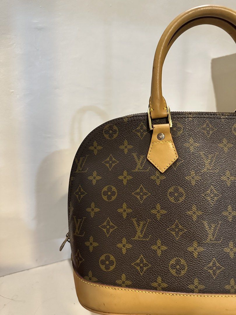 Louis Vuitton Monogram Alma Handbag (Category: Luxury Bags & Wallets) located in General Trias. Submitted by anjmp (Listing ID 1468261500, Image 2). Description: - Alma handbag in classic monogram canvas - Structured dome shape with natural Vachetta leather trim and rolled top handles - Secure top zipper closure with shiny gold-tone hardware - Spacious dark brown fabric-lined interior - jpn bale.