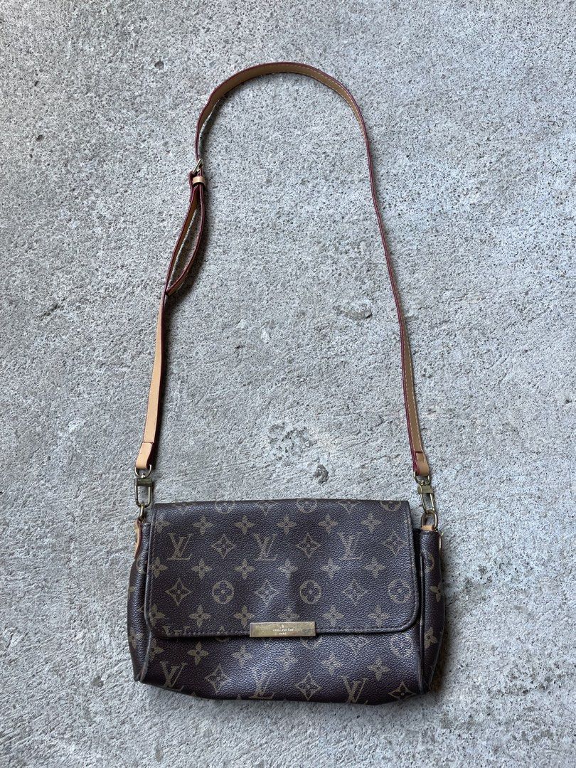 Louis Vuitton Monogram Canvas Crossbody Bag with Strap (Category: Luxury Bags & Wallets) located in Siniloan. Submitted by rethr1ft (Listing ID 1468085701, Image 1). Description: - Authentic Louis Vuitton crossbody bag in classic brown monogram canvas - Adjustable leather shoulder strap with gold-tone hardware - Secure front flap closure with engraved metal plaque - Condition: Visible wear along corner edges and light scratching on the metal plaq